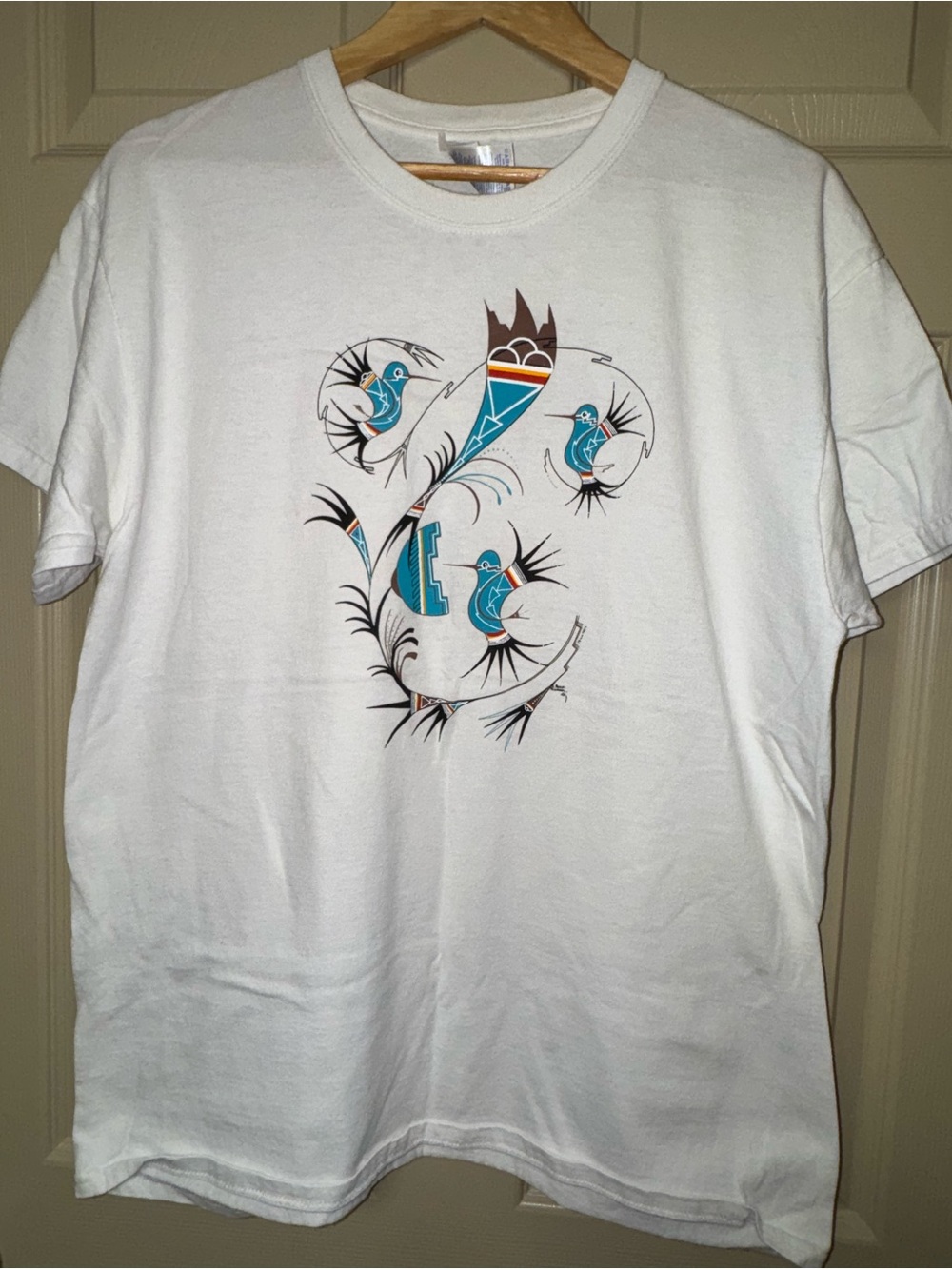 Southwestern native design tee with turquoise hummingbird decals